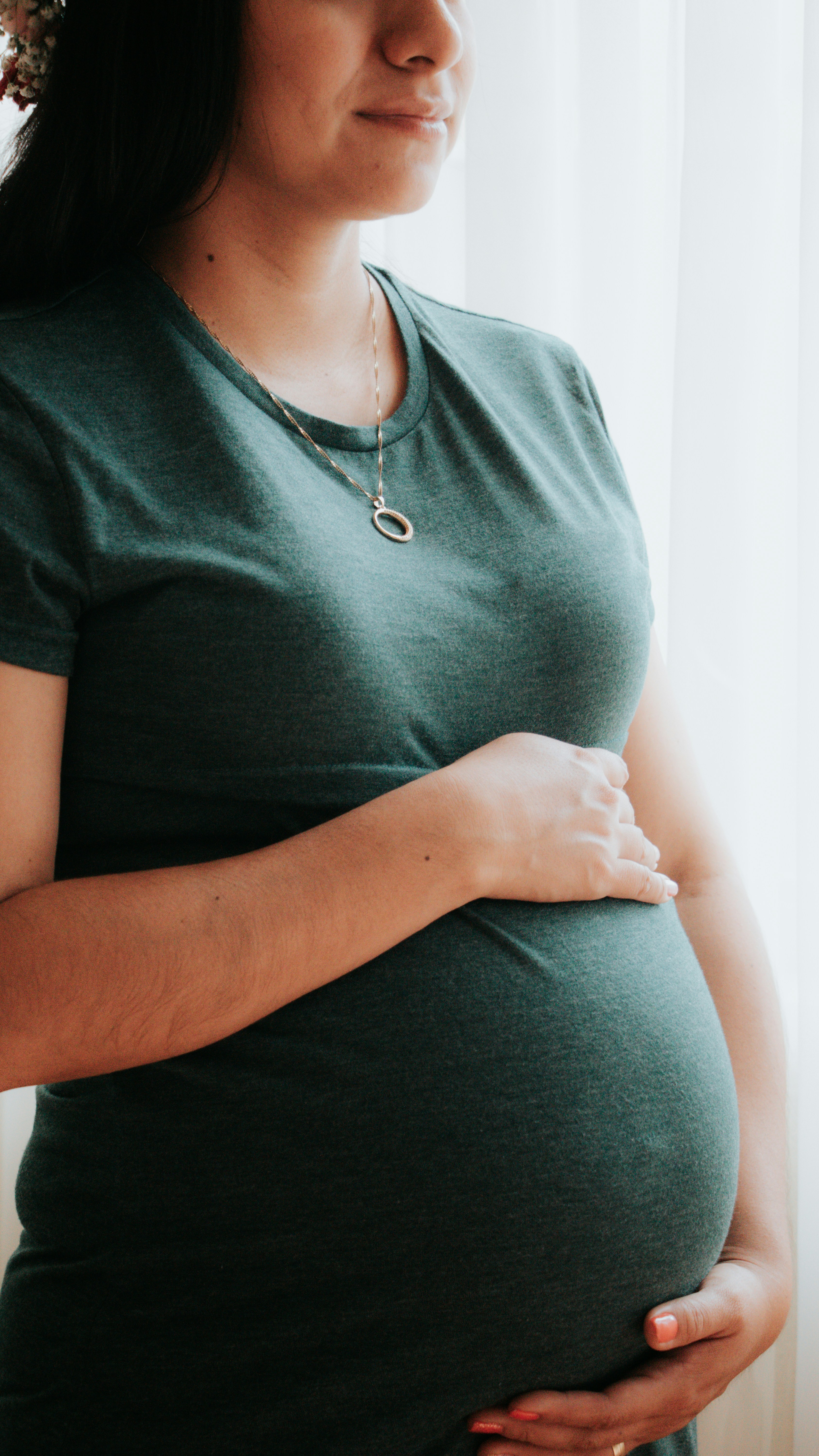 pregnant woman in green shirt